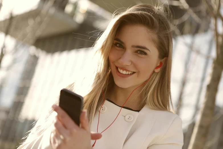a close up of a person holding a cell phone, girl wearing headphones, cheeky smile with red lips, multiple stories, avatar image