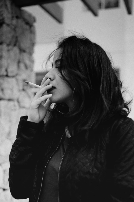 a black and white photo of a woman smoking a cigarette, pexels contest winner, sayem reza, dua lipa, 2 0 0 0 s, ameera al-taweel