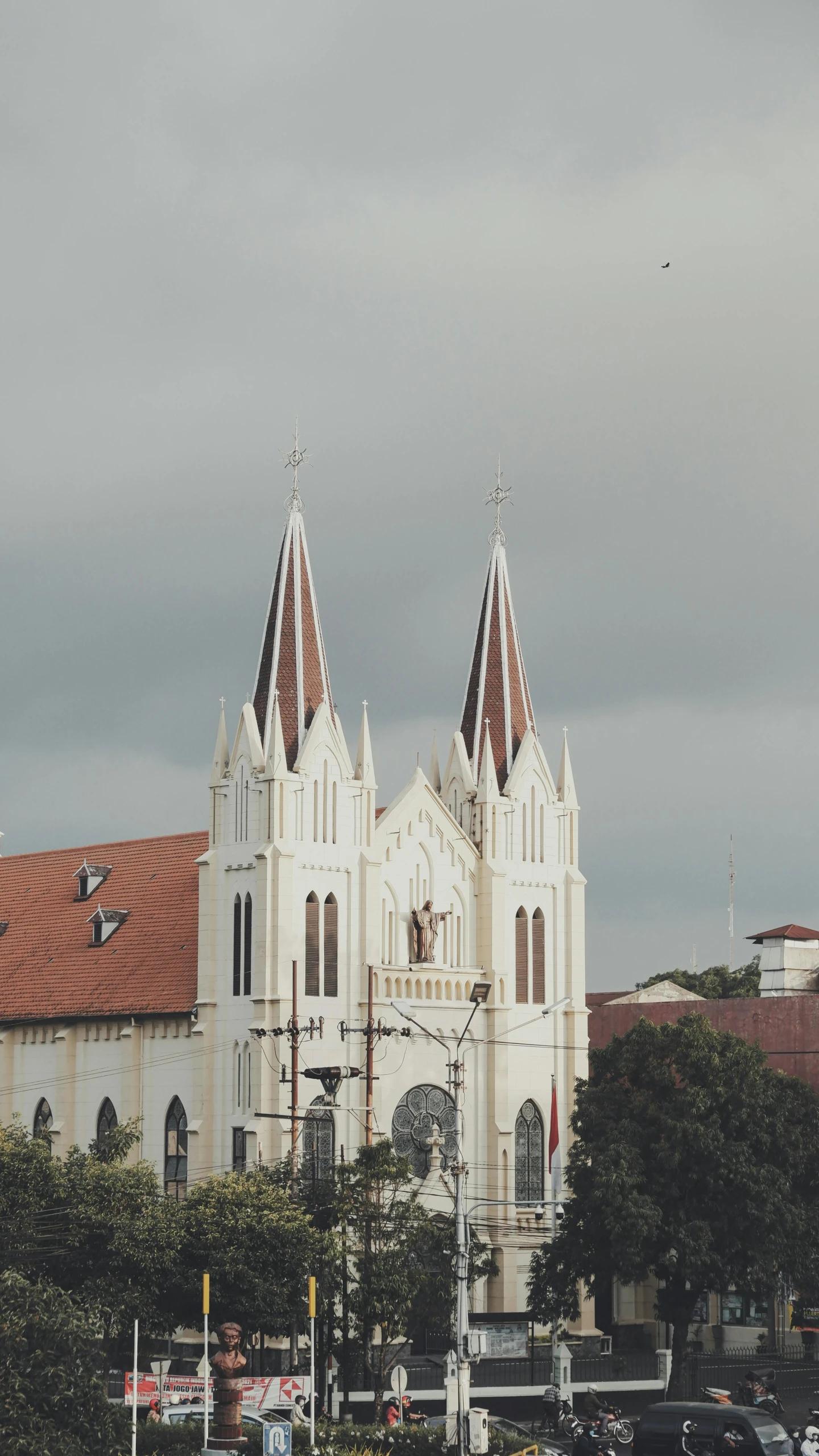 a large white church sitting on top of a lush green field, inspired by Bernardo Daddi, unsplash, south jakarta, brown, square, low quality photo