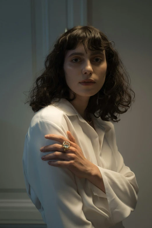 a woman in a white shirt posing for a picture, an album cover, inspired by Elsa Bleda, pexels contest winner, hyperrealism, ring, finn wolfhard, jewelry lighting, medium format. soft light