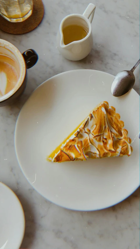 a piece of pie sitting on top of a white plate, inspired by Richmond Barthé, pexels contest winner, hurufiyya, yellow scheme, coffee, uk, marbled