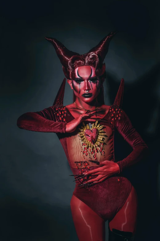 a man in a devil costume posing for a picture, an album cover, inspired by Ignacy Witkiewicz, transgressive art, bodypaint, bella poarch, instagram photo, horned