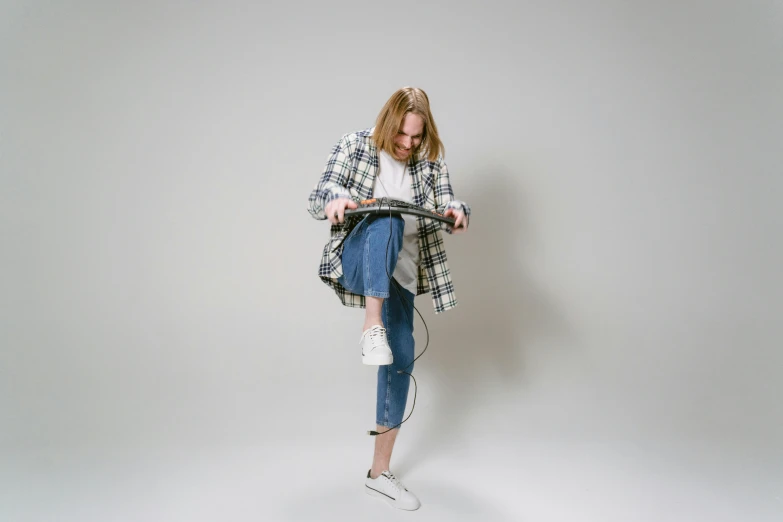 a woman sitting on top of a scooter, an album cover, unsplash, baggy jeans, featuring wires, tartan garment, studio shoot