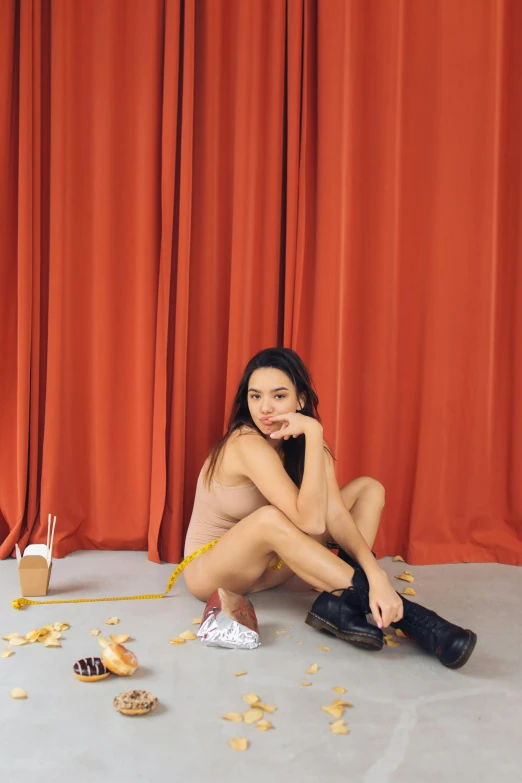 a naked woman sitting on the floor in front of a red curtain, inspired by Ren Hang, unsplash, with fries, dua lipa, steve zheng, showstudio