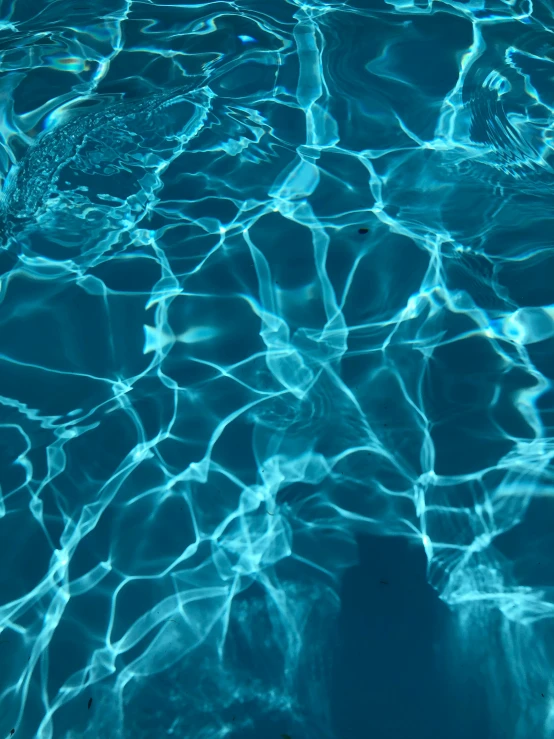 a pool filled with lots of blue water, by Carey Morris, unsplash, holography, refraction lights, ilustration, summer 2016, close-up photograph