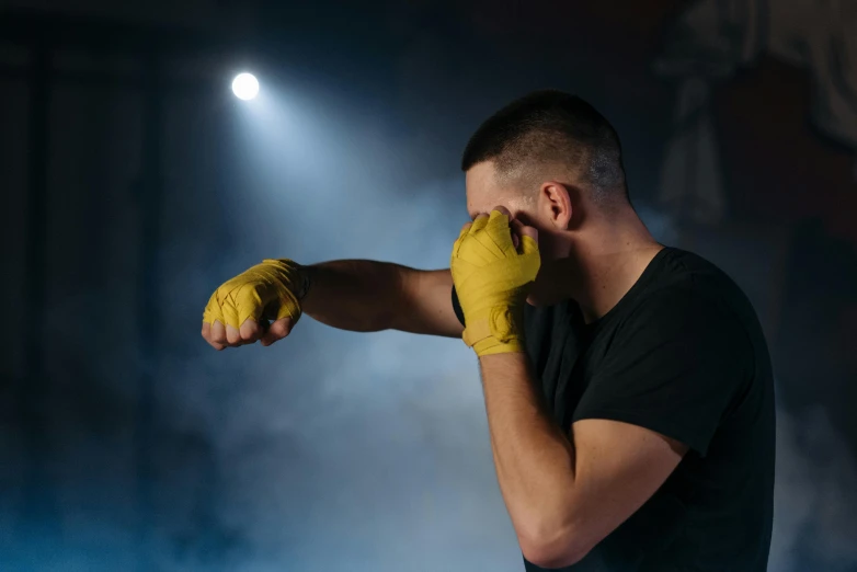 a man in a black shirt and yellow gloves, pexels contest winner, figuration libre, sucker punch, late night, swollen muscles, over it's head