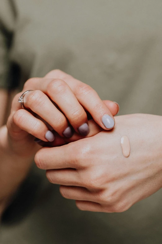 a close up of a person holding a cell phone, ivory make up, holding each other hands, foundation, warts