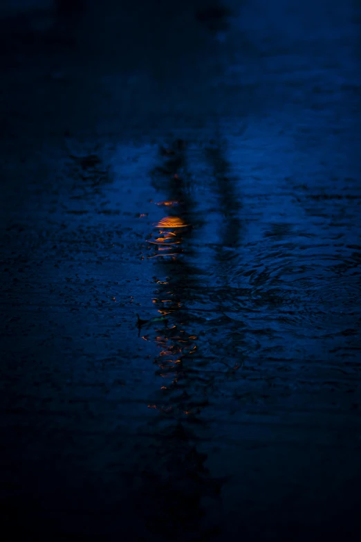 a street light reflecting in a puddle of water, unsplash, lyrical abstraction, dark blue + dark orange, low sun, color ( sony a 7 r iv, rainy