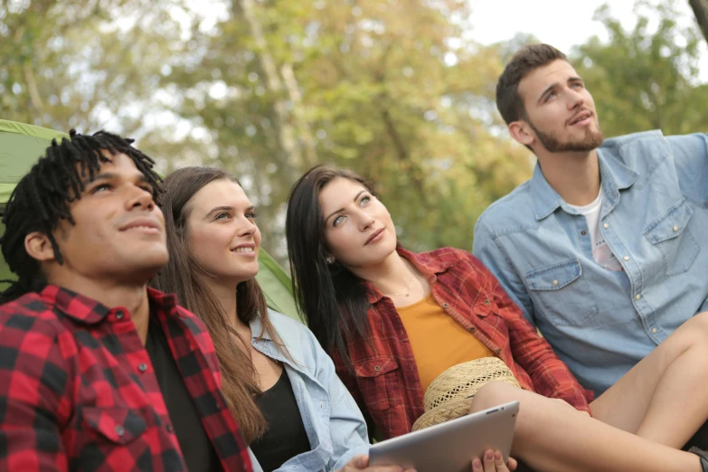 a group of young people sitting next to each other, shutterstock, renaissance, looking across the shoulder, 15081959 21121991 01012000 4k, college, nature outside