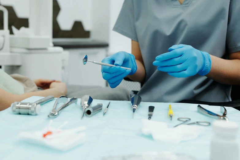 a close up of a person in a dentist's chair, trending on pexels, hurufiyya, surgical implements, on a white table, fiona staples, where a large