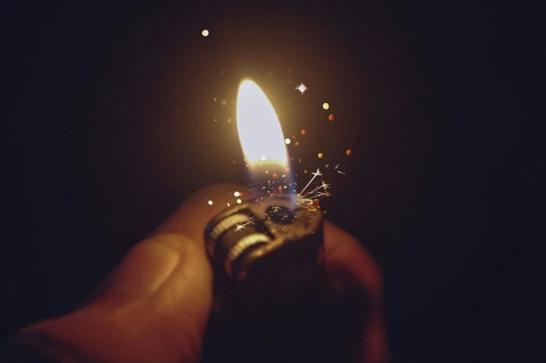 a person holding a lighter in their hand, pexels contest winner, twinkling and spiral nubela, tiny firespitter, retro effect, instagram post