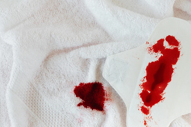 a piece of paper with a blood stain on it, by Julia Pishtar, trending on pexels, towels, health potion, stab wound, pulp fiction style