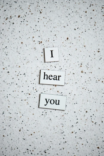 a piece of paper that says i hear you, by Sebastian Vrancx, unsplash, magnetic, 15081959 21121991 01012000 4k, metal ears, white