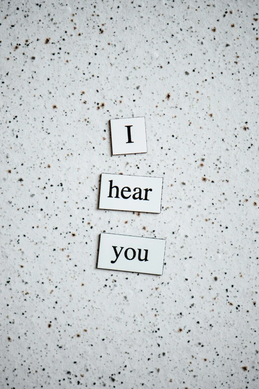 a piece of paper that says i hear you, by Sebastian Vrancx, unsplash, magnetic, 15081959 21121991 01012000 4k, metal ears, white