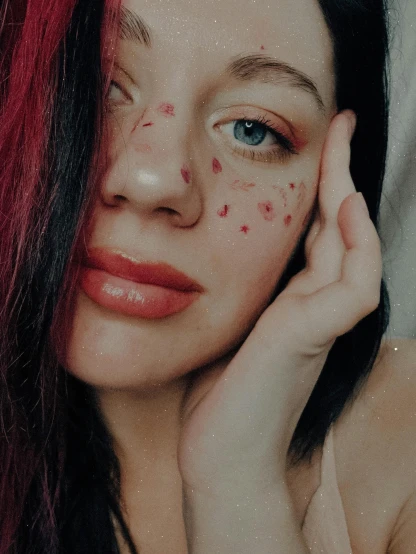 a close up of a woman with freckles on her face, an album cover, inspired by Elsa Bleda, trending on pexels, red hearts, y 2 k cutecore clowncore, 🤤 girl portrait, hand on cheek
