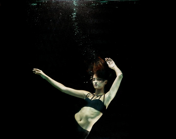 a woman in a black bikini under water, an album cover, unsplash, conceptual art, nishihara isao, taken in the late 2010s, model posing, cynthwave