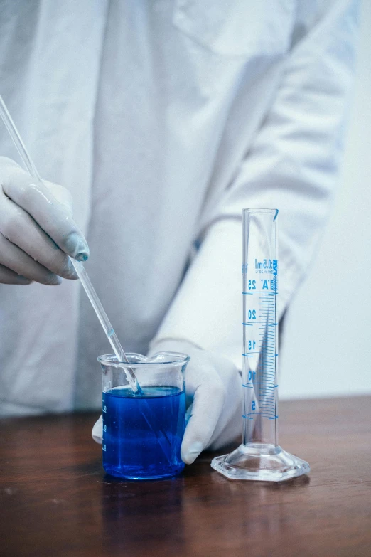 a close up of a person in a lab coat, pexels, blue gloves, fluids, tall shot, college