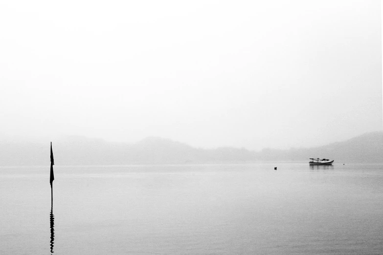 a black and white photo of a boat in the water, by Karl Buesgen, pexels contest winner, minimalism, hangzhou, pure white hazy overcast sky, white fog painting, lake view