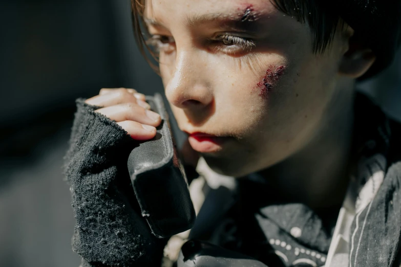 a close up of a person talking on a cell phone, inspired by Gottfried Helnwein, pexels contest winner, the last of us zombie, kids, posing ready for a fight, arya stark