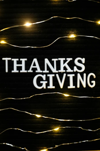 a lighted sign that says thanks giving, by Carey Morris, trending on unsplash, graffiti, medium detail, high quality photo, holiday, made of glazed