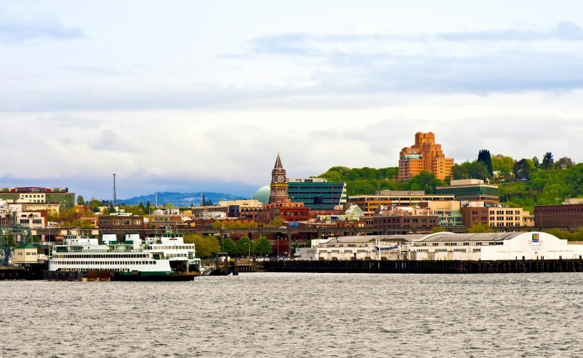 a large body of water with a city in the background, pexels contest winner, hudson river school, the photo was taken from a boat, cascadia, city docks, cornell