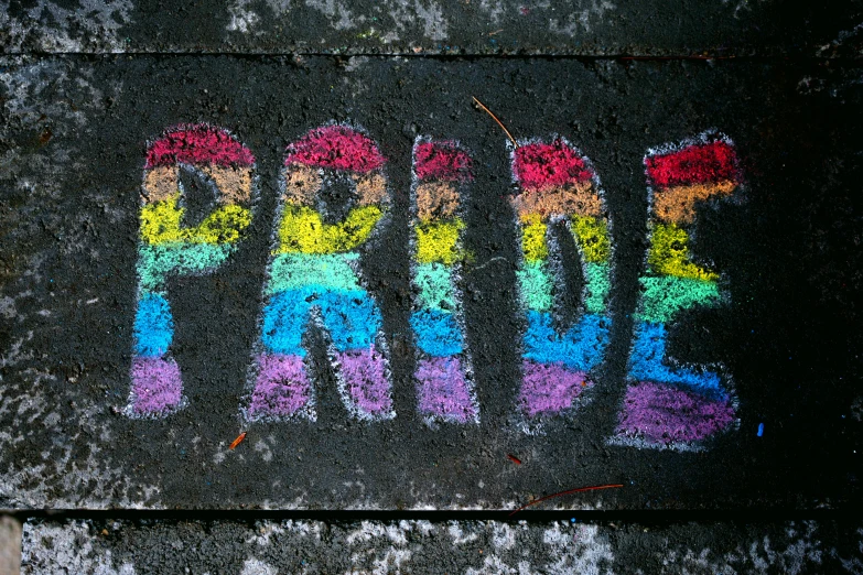 a sidewalk with the word pride painted on it, chalk art, trending on pexels, background image, lgbt art, album cover, schools