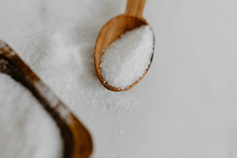 a wooden spoon sitting on top of a pile of sugar, by Emma Andijewska, trending on pexels, 🍸🍋, glossy white, textured base ; product photos, white