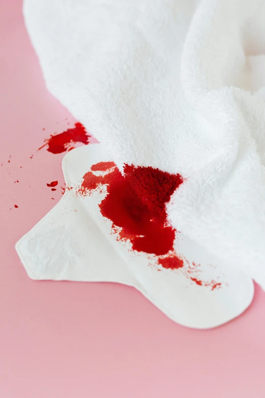 a white towel with a blood stain on it, by Julia Pishtar, happening, lipstick, cuts, wipe out, knee