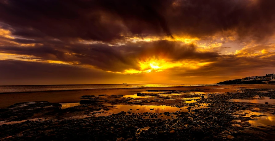 the sun is setting over the water on the beach, by Peter Churcher, pexels contest winner, yellow clouds, brown, super wide, fine art print