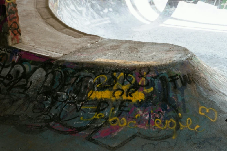 a man riding a skateboard up the side of a ramp, graffiti, acid pooling inside, etched inscriptions, sink, bottom body close up