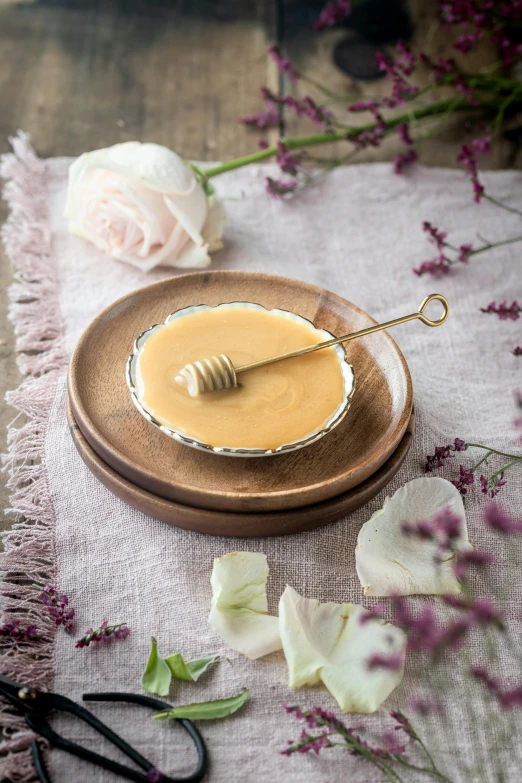 a bowl of honey and a pair of scissors on a table, inspired by Charles Le Roux, trending on pexels, rococo, soft blush, silver platter, on a wooden plate, blonde cream