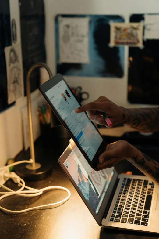 a man sitting at a desk using a laptop computer, trending on pexels, holding up a night lamp, ipad pro, adafruit, behance lemanoosh