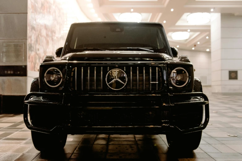 a black suv parked inside of a building, unsplash, renaissance, mercedez benz, front facing camera, museum quality, $100000000