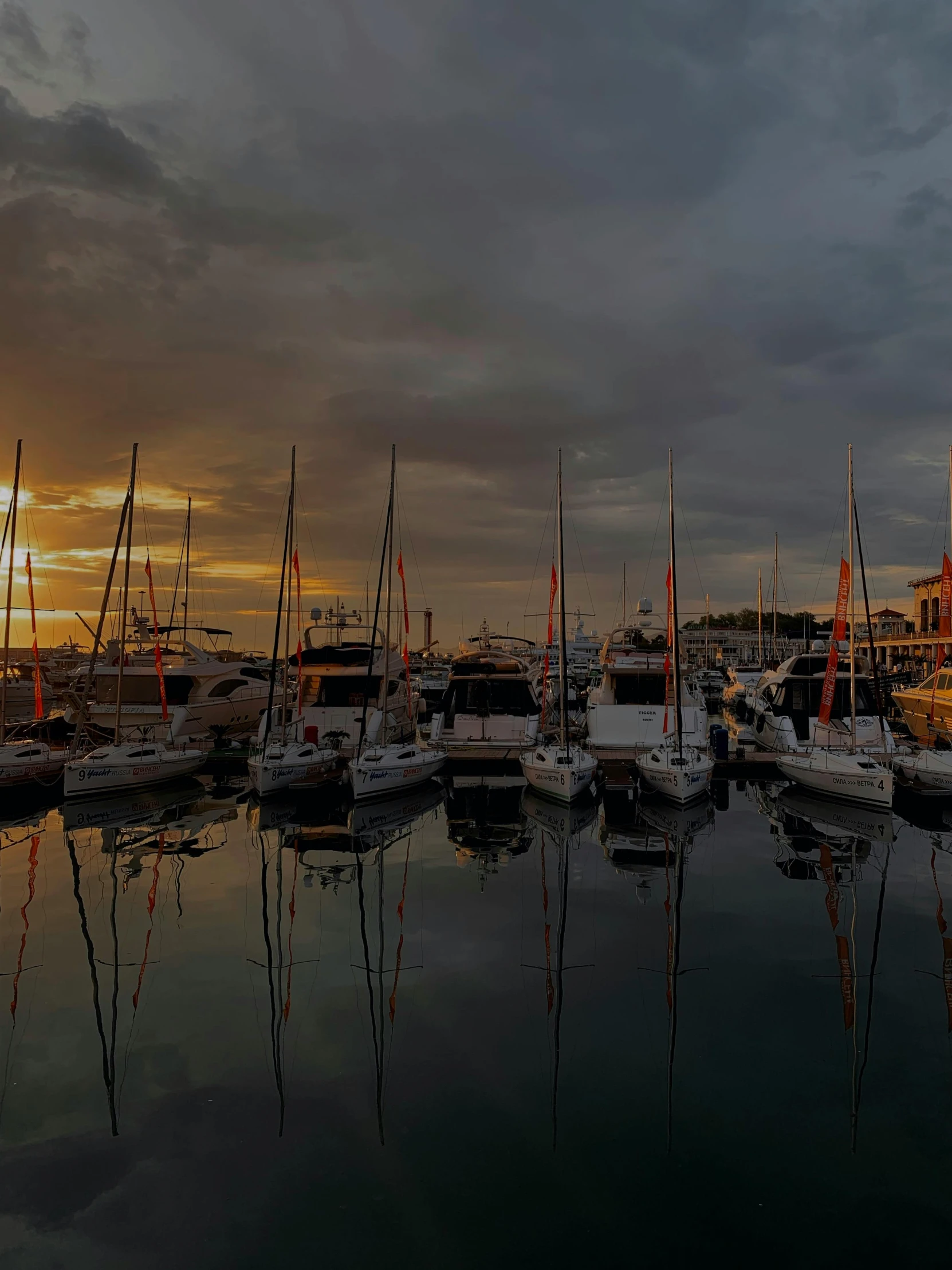 a harbor filled with lots of boats under a cloudy sky, a picture, pexels contest winner, sunset lighting ominous shadows, cannes, thumbnail, portrait photo