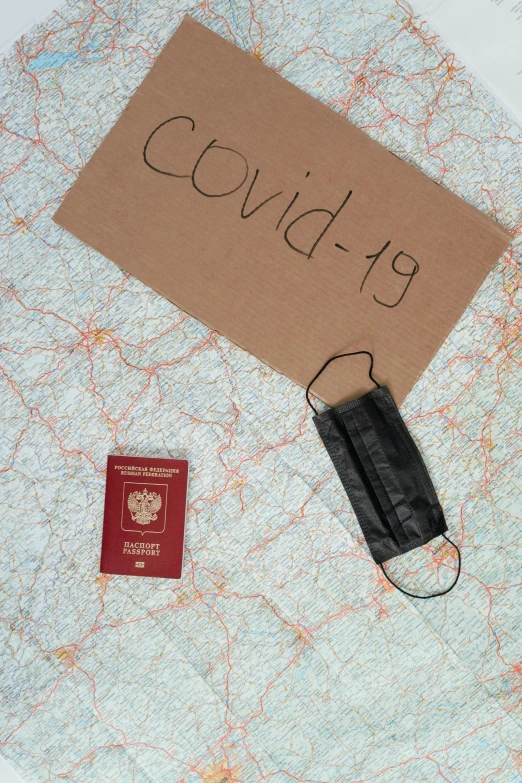 a piece of paper sitting on top of a map, an album cover, covid-19 as a human, passport, in russia, thumbnail