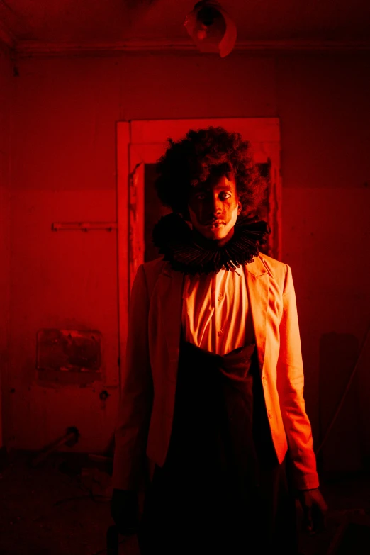 a woman standing in a dark room with a red light, inspired by Carrie Mae Weems, in a halloween style, the ringles, imaan hammam, inside haunted house