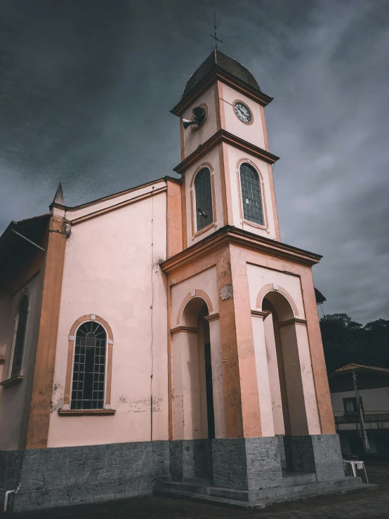 a church with a clock on the front of it, an album cover, inspired by Francisco Oller, pexels contest winner, brazil, dark overcast weather, color image, square