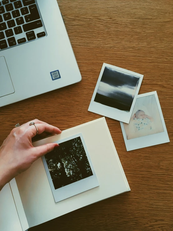 a laptop computer sitting on top of a wooden table, a polaroid photo, inspired by Elsa Bleda, pexels contest winner, computer art, diary on her hand, japanese collection product, cream paper, museum photo