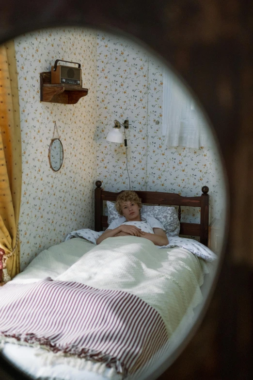 a small child laying in a bed in a room, inspired by Konstantin Somov, photorealism, shot on anamorphic lenses, 1990s bedroom, cottagecore, 1999 photograph