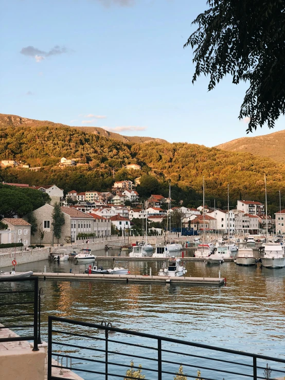 a body of water with a bunch of boats in it, by Ivana Kobilca, croatian coastline, square, evening light, low quality photo