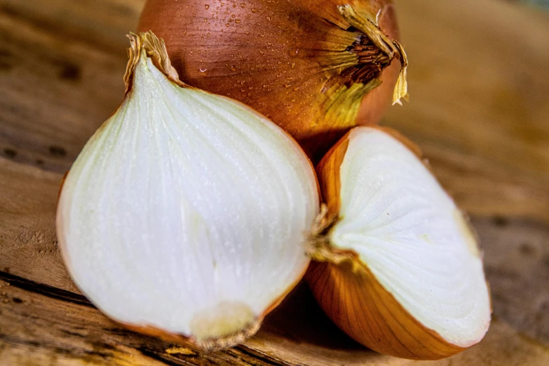 a couple of onions sitting on top of a wooden table, upclose, illustratioin, listing image, stacked image