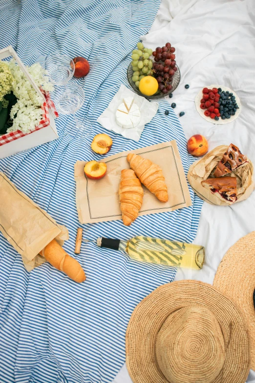 a couple of straw hats sitting on top of a bed, having a picnic, baking french baguette, themed after wine, instagram post