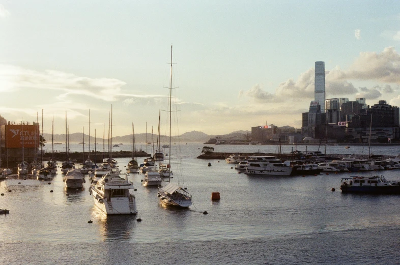 a large body of water filled with lots of boats, inspired by Thomas Struth, pexels contest winner, hong kong, filtered evening light, john pawson, medium format film photography