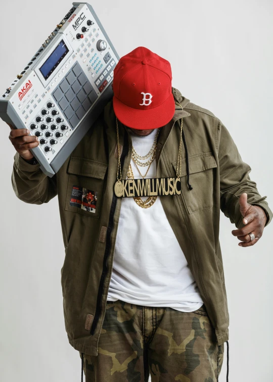 a man in a red hat is holding a radio, an album cover, by Bascove, rapper bling jewelry, profile image, keyboardist, wearing a baseball cap