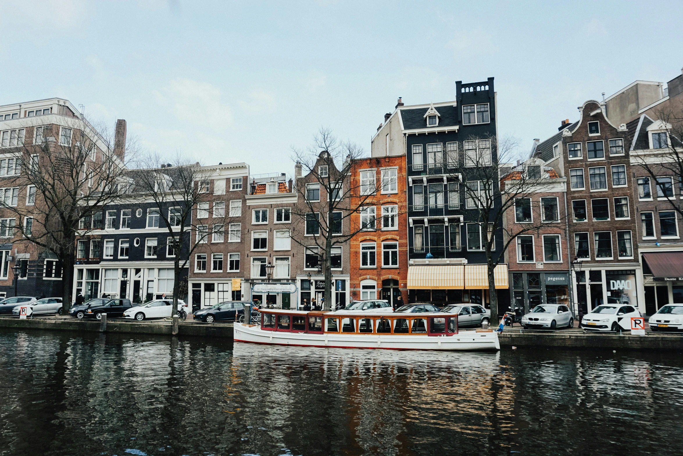 a boat that is sitting in the water, by Jan Tengnagel, pexels contest winner, neoclassicism, dutch houses along a river, 🚿🗝📝