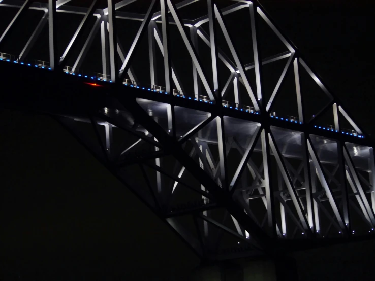 a bridge that is lit up at night, a portrait, inspired by Bruce Munro, pexels contest winner, detail structure, grey, blue leds, australian winter night