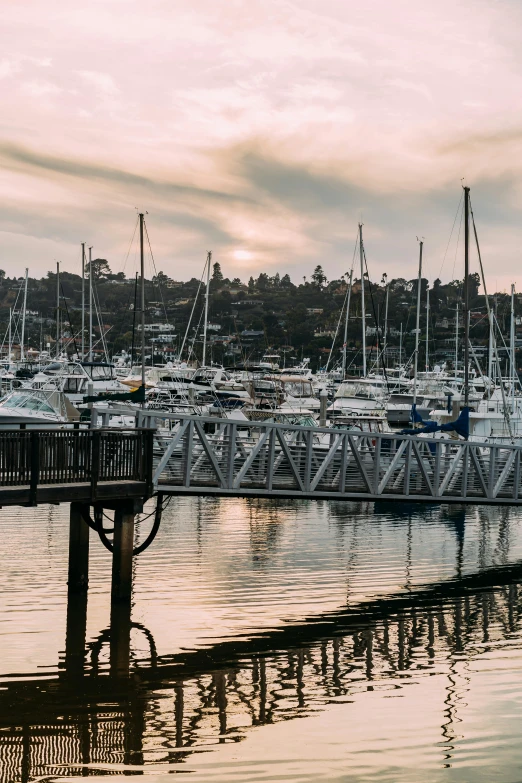 a harbor filled with lots of boats under a cloudy sky, manly, soft golden hour lighting, boat dock, tie-dye