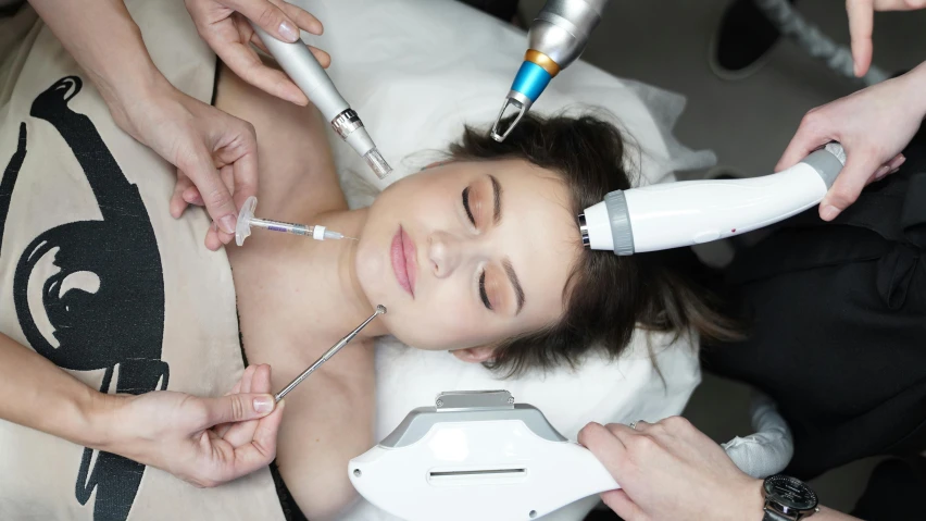 a woman getting a procedure in a beauty salon, a photo, by Adam Marczyński, shutterstock, white porcelain skin, freezing, digital medical equipment, thumbnail