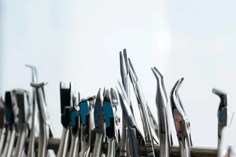 a bunch of tools sitting on top of a table, dentist, long fingernails, jovana rikalo, stainless steel