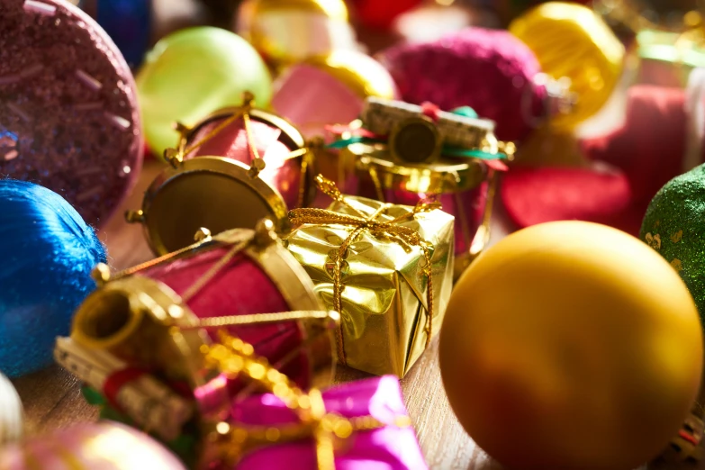 a pile of christmas ornaments sitting on top of a table, a tilt shift photo, pexels, process art, bright saturated colours, thumbnail, hot pink and gold color scheme, presents